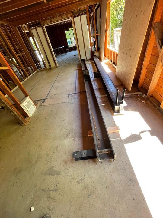 On-site steel beam, post, base plate, and bracket fabrication.