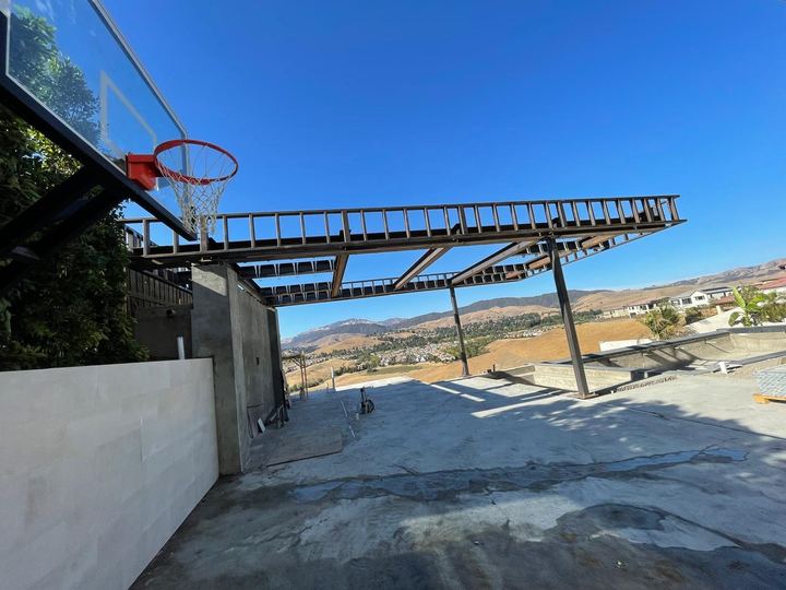 Custom fabricated roof steel structure with welded beams, framing, and support connections.