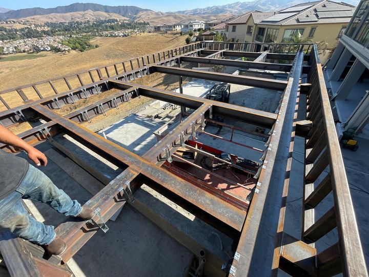 Steel roof structure fabrication with welded framing, beams, and job-site fit-up.