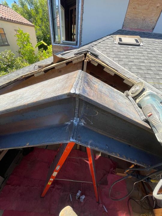 Steel beam welding and reinforcement around roofline and framing conditions.