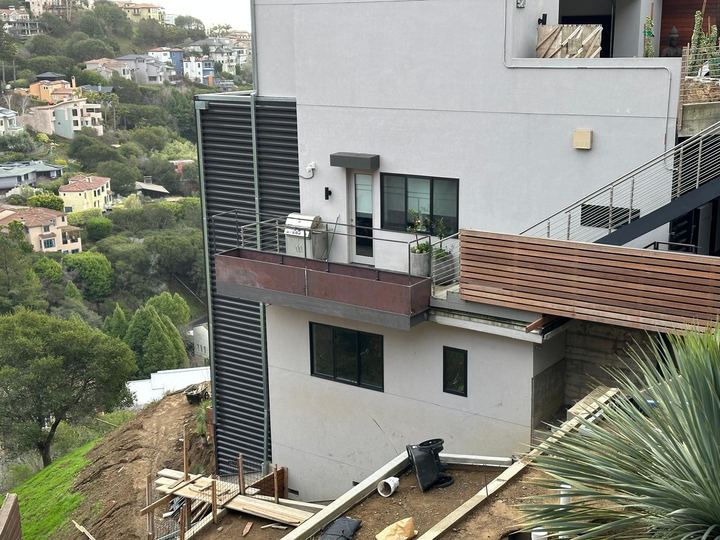 Fabricated planter box metalwork built to fit the balcony and exterior wall conditions.