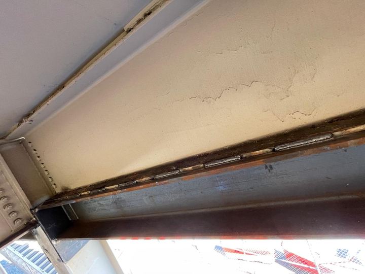 Beam repair and reinforcement welding below overhangs and soffit areas.