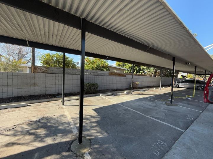 Steel support posts and welded canopy framing for covered areas.